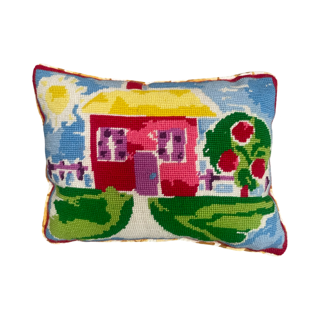 Hand embroidered tapestry showing a playful image of a bright little house with a big tree and lovely sunshine. Bright primary colours